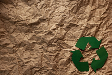Recycle symbol on parcel paper as background texture. Recycling concept and brown paper