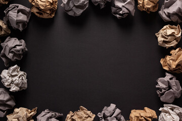Crumpled paper balls on black background texture. Inspiration creative idea concept