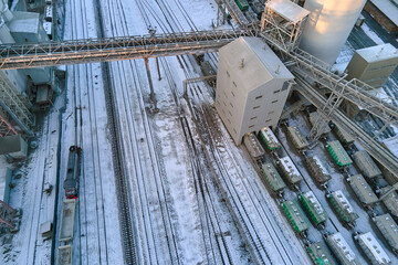 Aerial view of cargo train cars loaded with construction goods at mining factory. Railway...