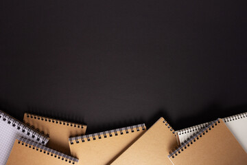 Notebook on black paper background texture. Creative idea concept