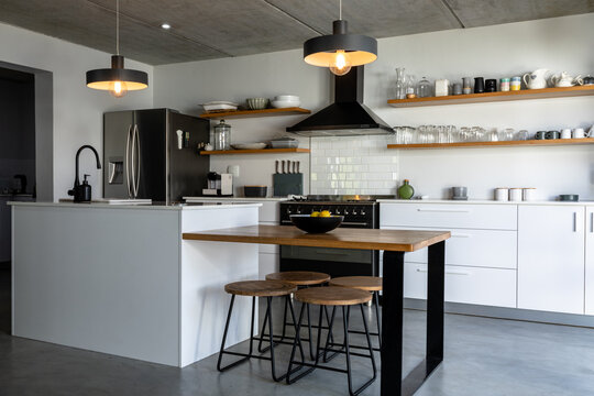 Interior of modern kitchen with illuminated pendant lights over kitchen island