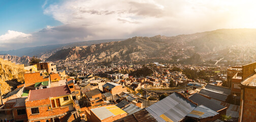 sunset with view of the city of la paz in bolivia in the andes mountain range of south america with blue sky with clouds