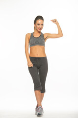 athletic girl in training clothes posing on a white background in the studio in full growth
