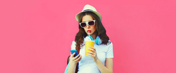 Summer colorful portrait of stylish young woman drinking fresh juice listening to music in...