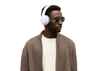 Portrait of african man in wireless headphones listening to music looking away isolated on white...