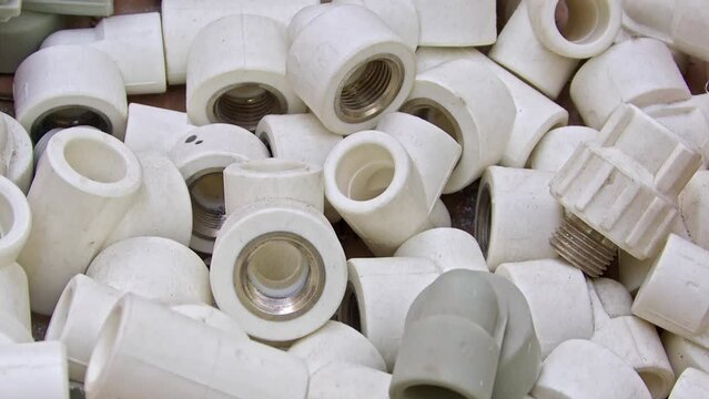 Many White Pvc Water Supply Pipe Fittings Close Up Footage.