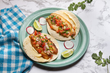 Fish tacos with fresh sauce and mayonnaise. Mexican food