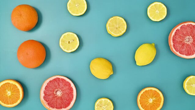 Tropical summer pattern with citrus fruits on vivid blue background. Stop motion flat lay