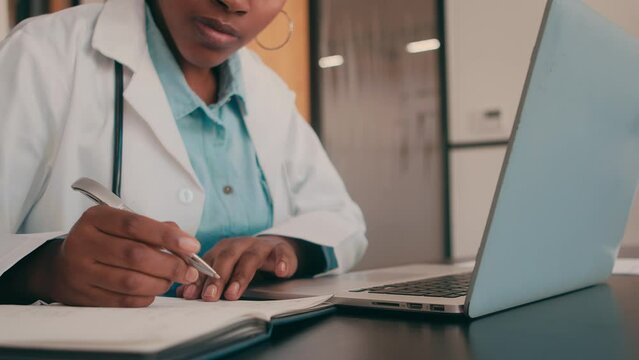 4k video of an unrecognizable female doctor working on her computer