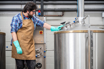 Man working on modern brewery. High quality photography