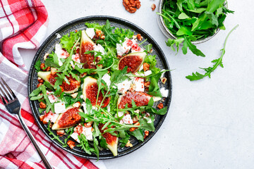 Delicious summer salad with sweet  figs, white feta cheese, walnuts, arugula and jam vinegar...