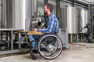 Man in wheel chair working in Brewery factory. High quality photography