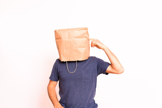 Anonymous pensive man with paper bag on his head.