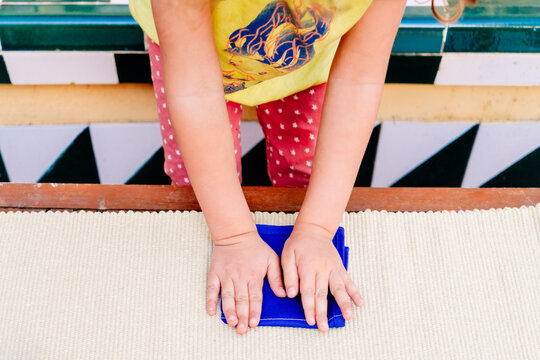 Folding napkins for children is a task to improve the fine motor skills of the hands of the students of montessori schools.