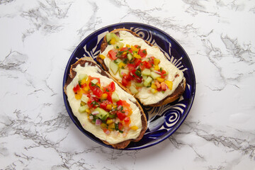 Molletes with Oaxaca cheese and pico de gallo sauce. Mexican food