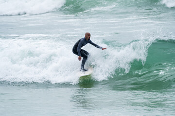 Surfer riding waves