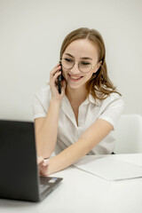 Happy smiling businesswoman having a business call, discussing meetings, planning her work day, using smartphone.