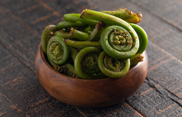 Fresh Fiddlehead or Ostrich Fern .on a Old Wooden Table