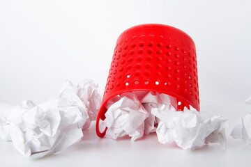 Trash can. Full basket. Crumpled paper in a basket.