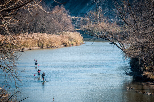 Stand up paddle boarding down river
