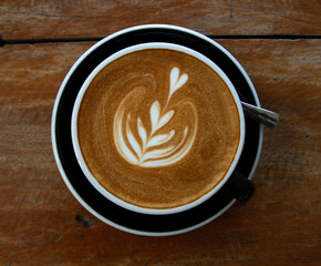 Hot coffee in a cup of coffee on a wooden table