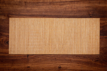 Bamboo mat on teak table top. tea table. Wooden frame on wood background.