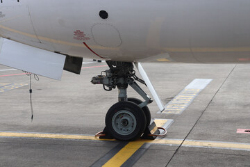 Closeup of an airplane wheel on the runway