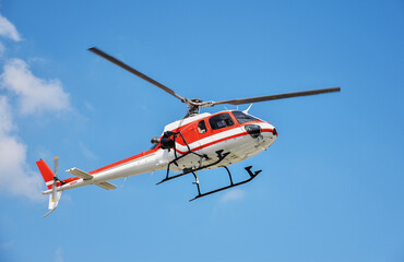 Fototapeta na wymiar Helicopter with camera mounted on blue sky