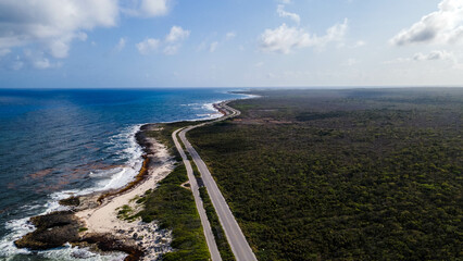 Overhead drone shot of swimmers on a tropical beach in Cozumel, Mexico.