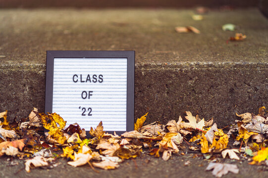 Class of 22 texts on a whiteboard with yellow leaves around