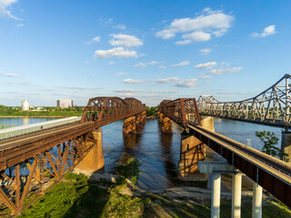 Drone view of the Memphis Arkansas Memorial Bridge,  Frisco Bridge and Harahan Bridge on Interstate 55 crossing the Mississippi River From Arkansas to Tennessee. - obrazy, fototapety, plakaty
