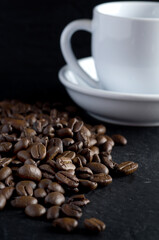 Coffee Beans and White Cup on Dark Background