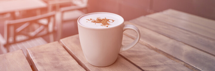 drinking coffee in outdoor cafe. Tasty latte in mug. Lunch casual atmosphere. Standing beverage. Lifestyle cozy morning. No people. Hotel breakfast