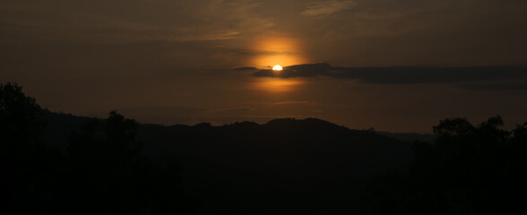 Idah view at sunrise, the sun is covered with yellow clouds