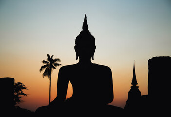 Obraz premium Sunset at Wat Mahathat buddha and temple in Sukhothai Historical Park