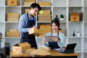 Asian guy and girl,SME Online business,Work at home concept,SME,Asian business couple,checking customer order online shipping,Work at home.