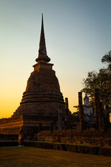 Sunset at Wat Mahathat buddha and temple in Sukhothai Historical Park