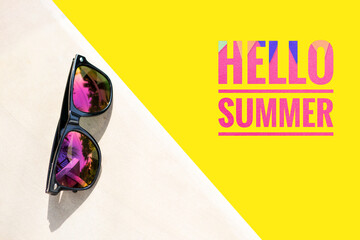Hello summer banner on yellow background with sunglasses, first day of summer holiday, colorful summer