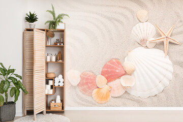 Shelf unit and folding screen near wall with print of sea shells in bathroom