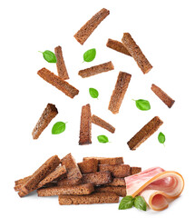 Falling rye croutons with basil leaves and bacon on white background