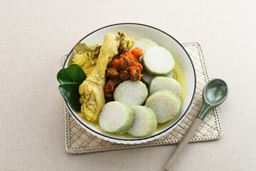 Lontong Opor with Sambal Goreng Ati, Indonesian traditional food or Eid menu. Opor made from chicken cooked with coconut milk and spices.
