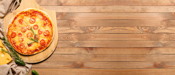 Tasty baked pizza on wooden background with space for text