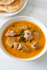 Chicken curry soup with roti