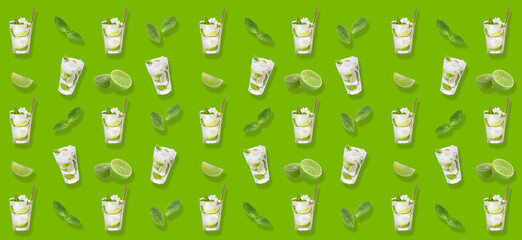 Glasses of fresh mojito with lime and mint on green background - obrazy, fototapety, plakaty
