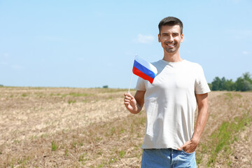 Young man with national flag of Russia outdoors