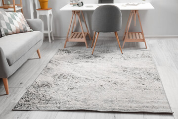 Soft carpet on wooden floor in stylish room interior