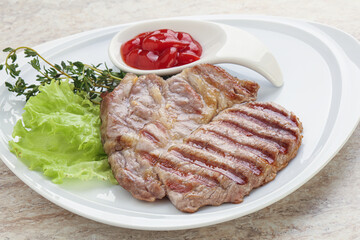 Grilled pork neck steak with ketchup