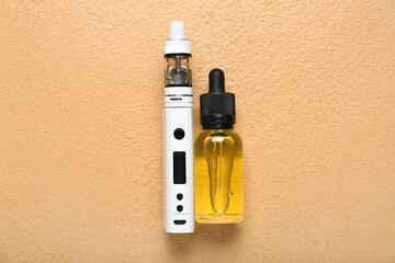 Modern vape mod and oil on beige background