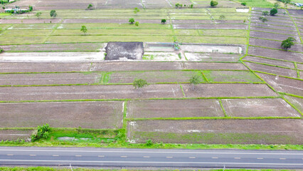 Aerial drone view of green fields and farmland.