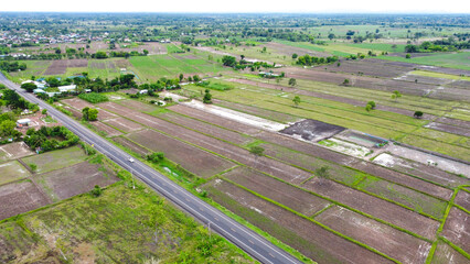 Aerial drone view of green fields and farmland.